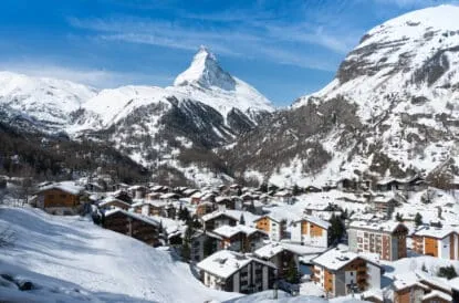 Zermatt city view with Matterhorn background in a sunny day of winter season at Zermatt, Switzerland. Zermatt village with snow on the roof. Cityscape view from Gornergrat Bahn.