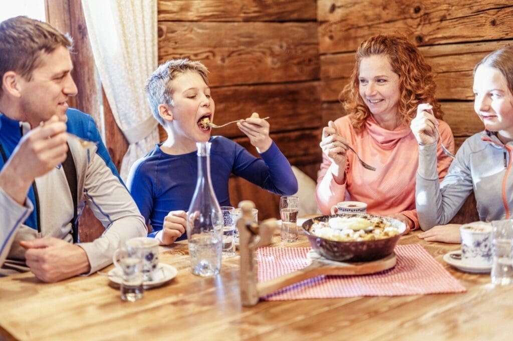 Skiing in Tirol, Austria - A family enjoying local dishes in Ski Juwel Alpbachtal Wildschoenau. Credit shootandstyle