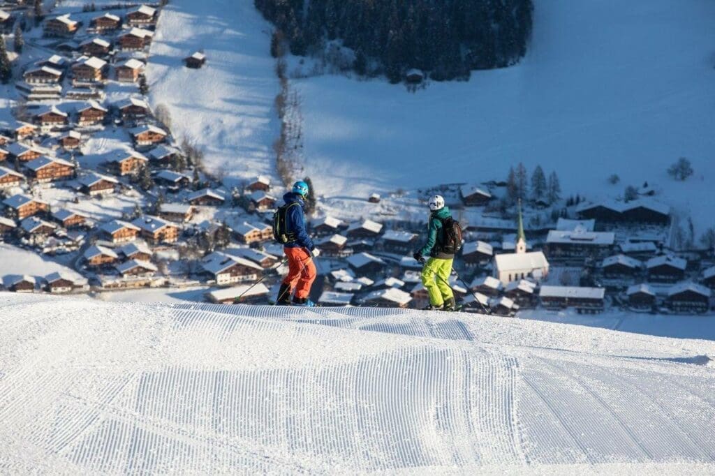 Skiing in Tirol, Austria - Skiers with a view of Alpbach