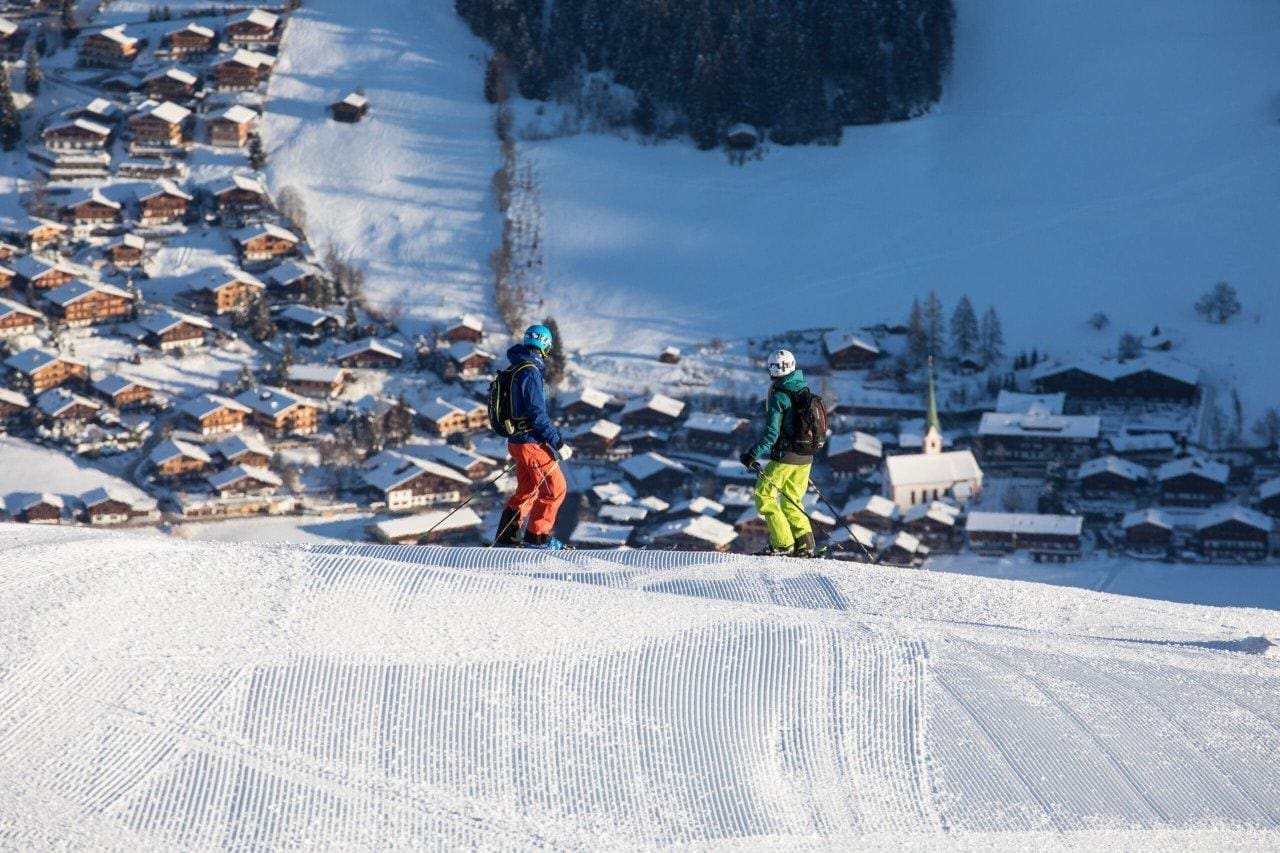 Skiing in Tirol, Austria - Skiers with a view of Alpbach