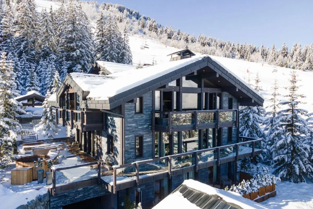 a modern luxe chalet pictured, covered in snow