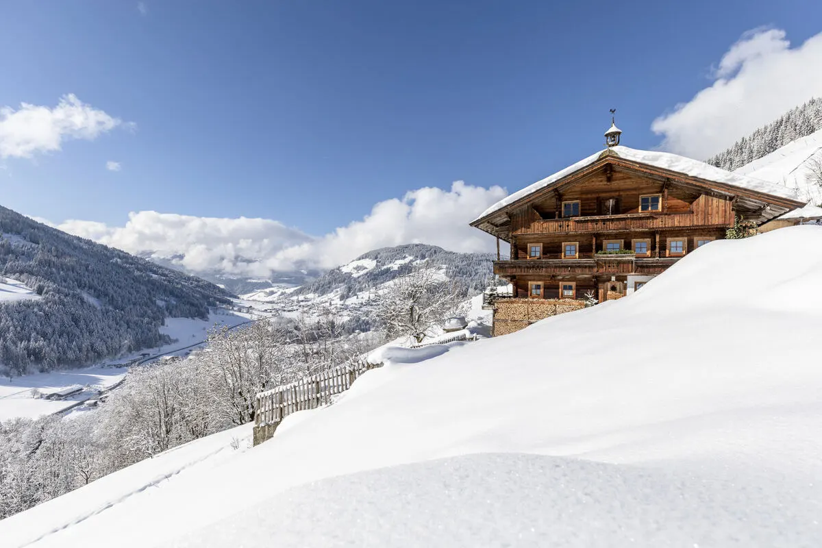 a wooden chalet covered in snow