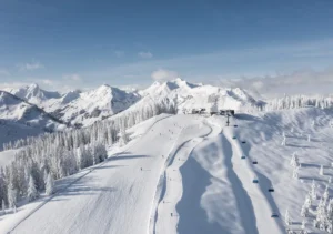 Aerial view of snowy pistes, lifts, and mountains in Saalbach Hinterglemm