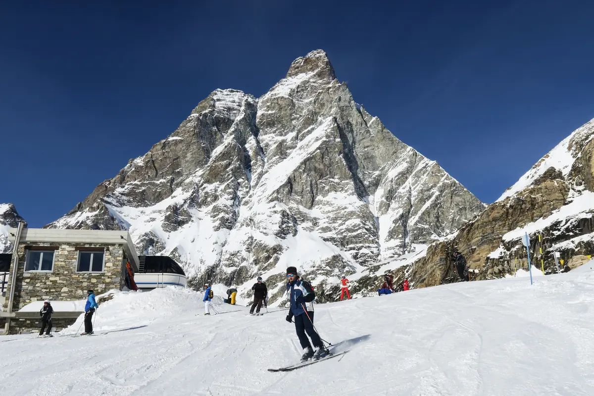 Skier turning on the high-altitude slopes of Cervinia beneath the Matterhorn in Aosta Valley