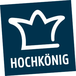 Hochkönig tourism logo with white crown symbol on a dark blue background