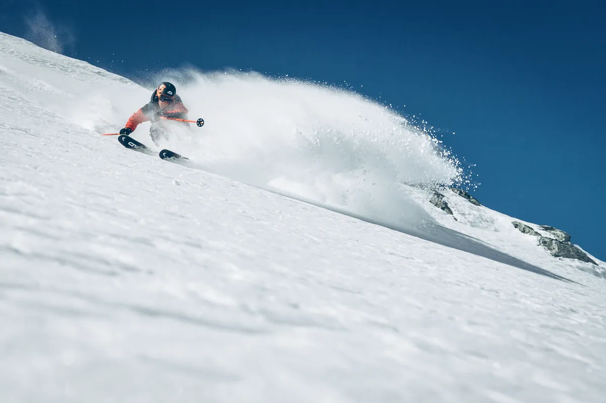A skier enjoying fresh snow on the slopes