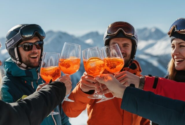 Outdoor photo of apres ski party with aperol spritzes and friends