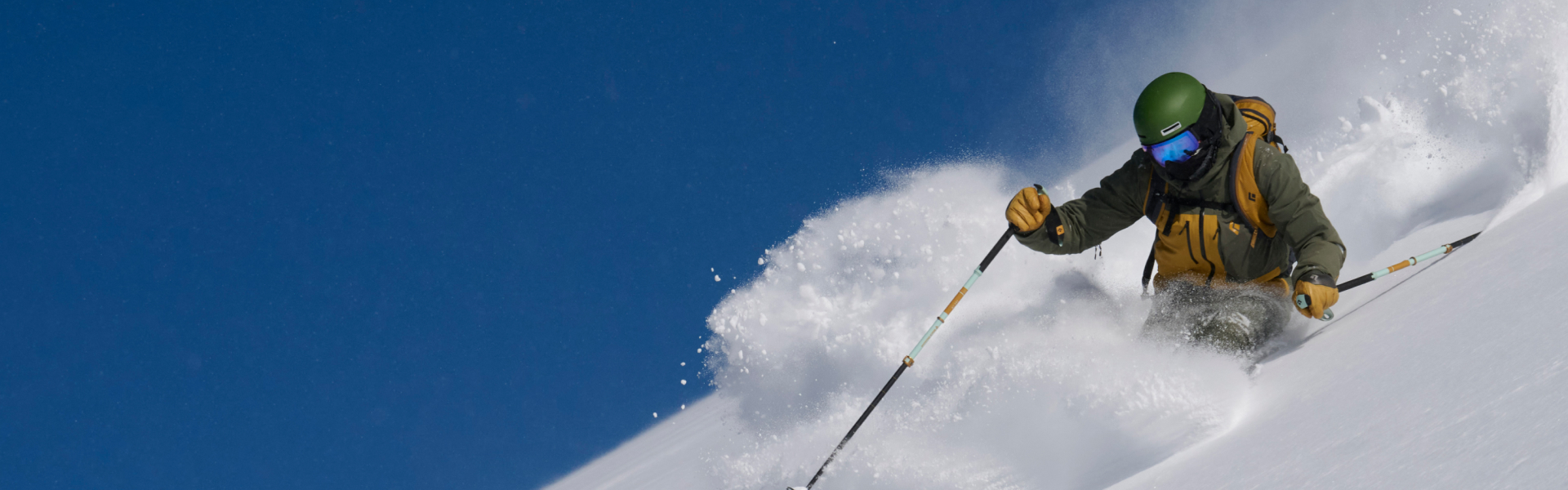 Skier making fresh tracks in deep powder off piste