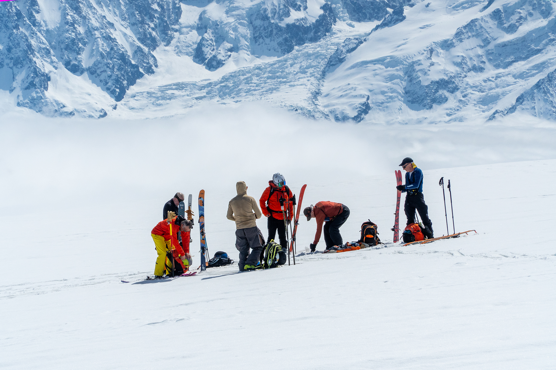 Ski tourer climbing over a mountain ridge
