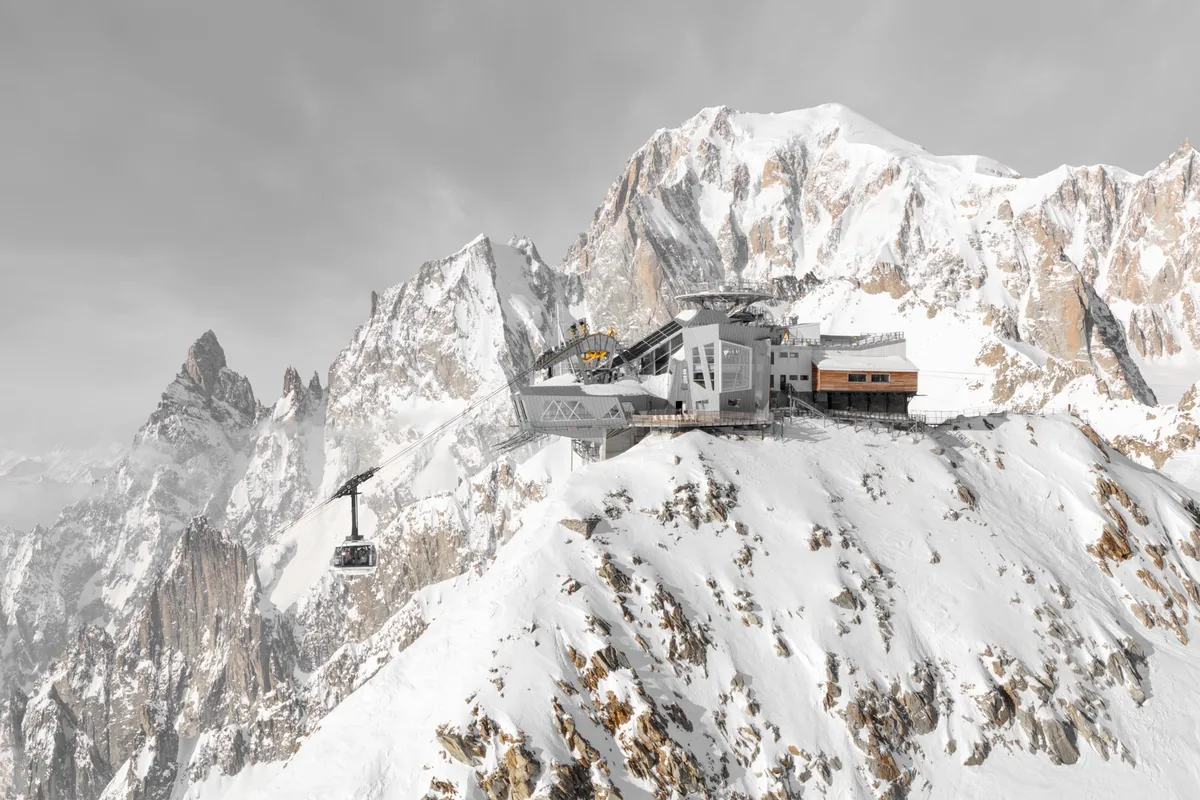 Skyway Monte Bianco cable car station surrounded by snow-covered peaks in the Mont Blanc massif.