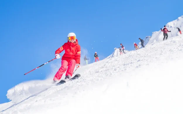 Skier descending a snowy slope at Alpe d’Huez