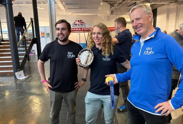 Charlotte Bankes holding the Pery Medal and her Olympic gold medal with Ski Club of Great Britain representatives at the London Snow Show